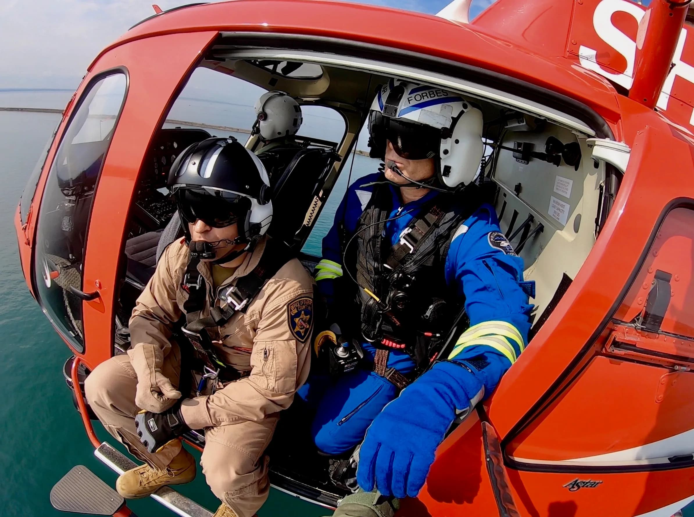 P1AR rescue aircrew aboard an AS350 AStar helicopter over water