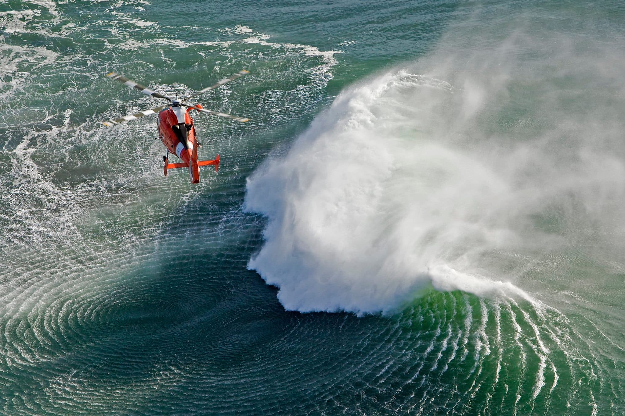 HH-65 helicopter in high surf rescue operations
